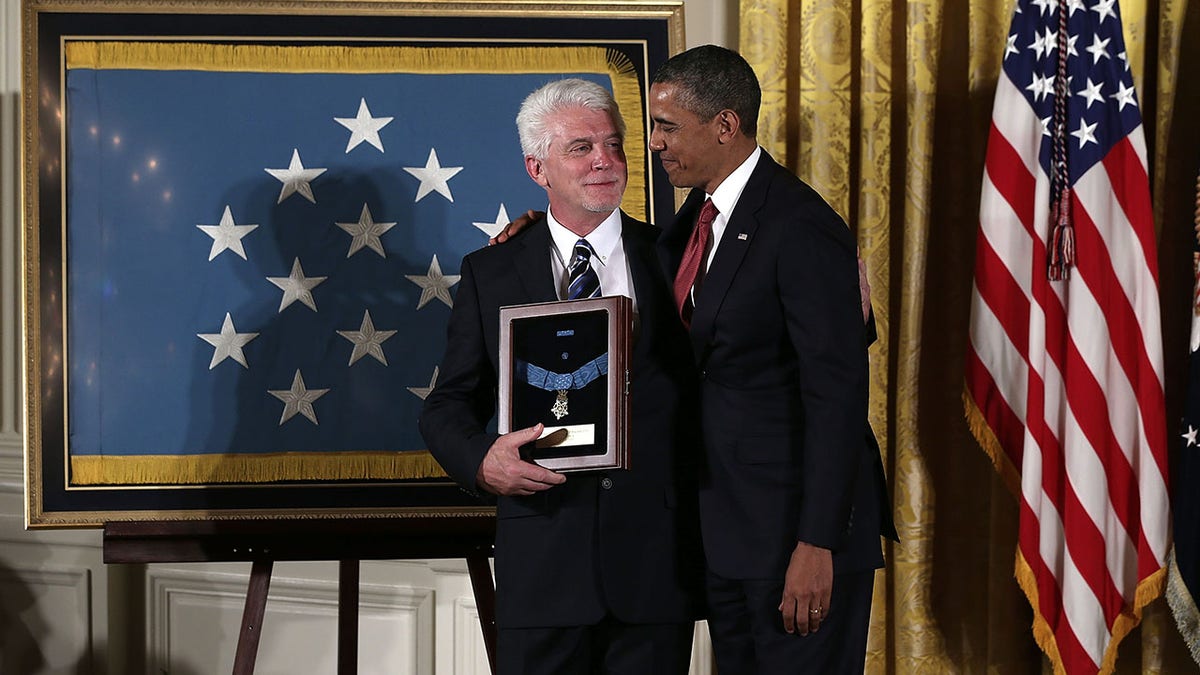 Barack Obama and another man with Medal of Honor framed