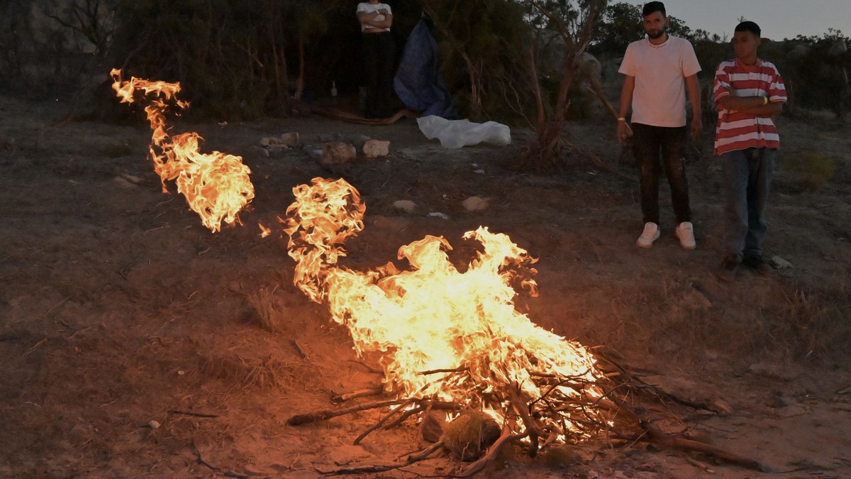 Migrants along the U.S.-Mexico border start fires to keep warm