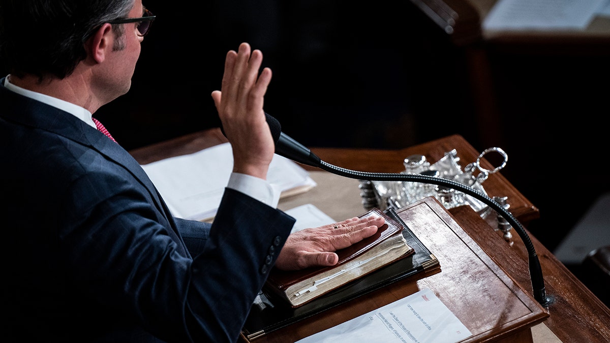 Johnson's hand on a Bible