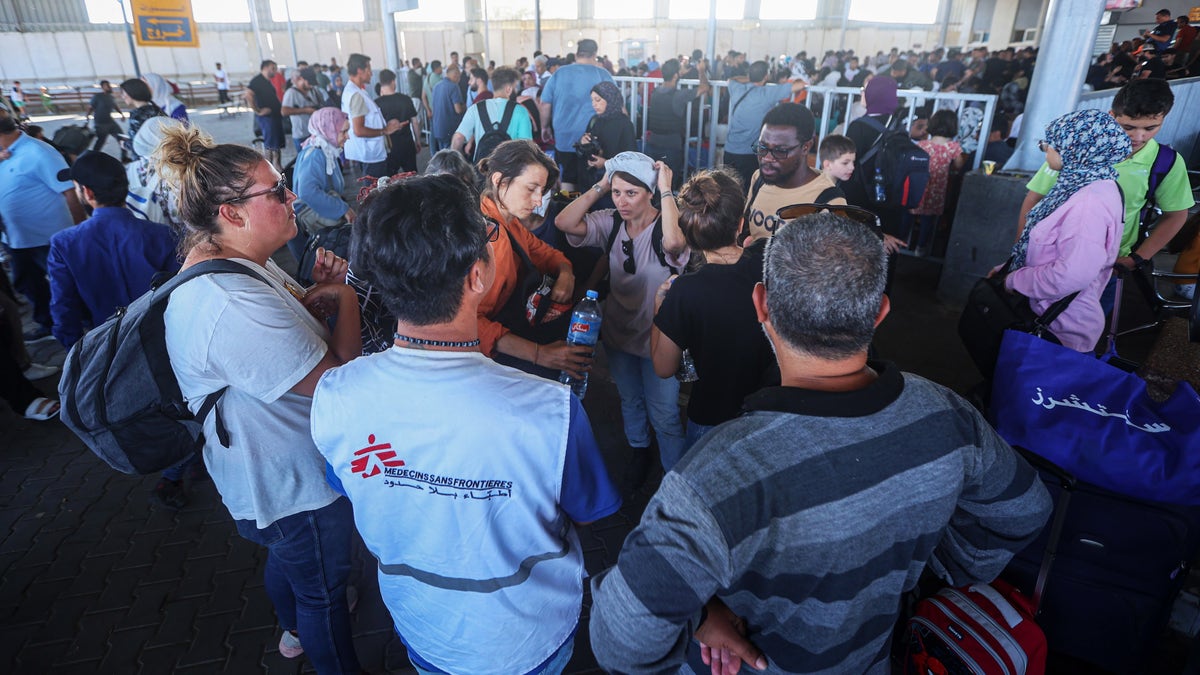 Foreign nationals stuck in palestine waiting at rafah crossing into egypt