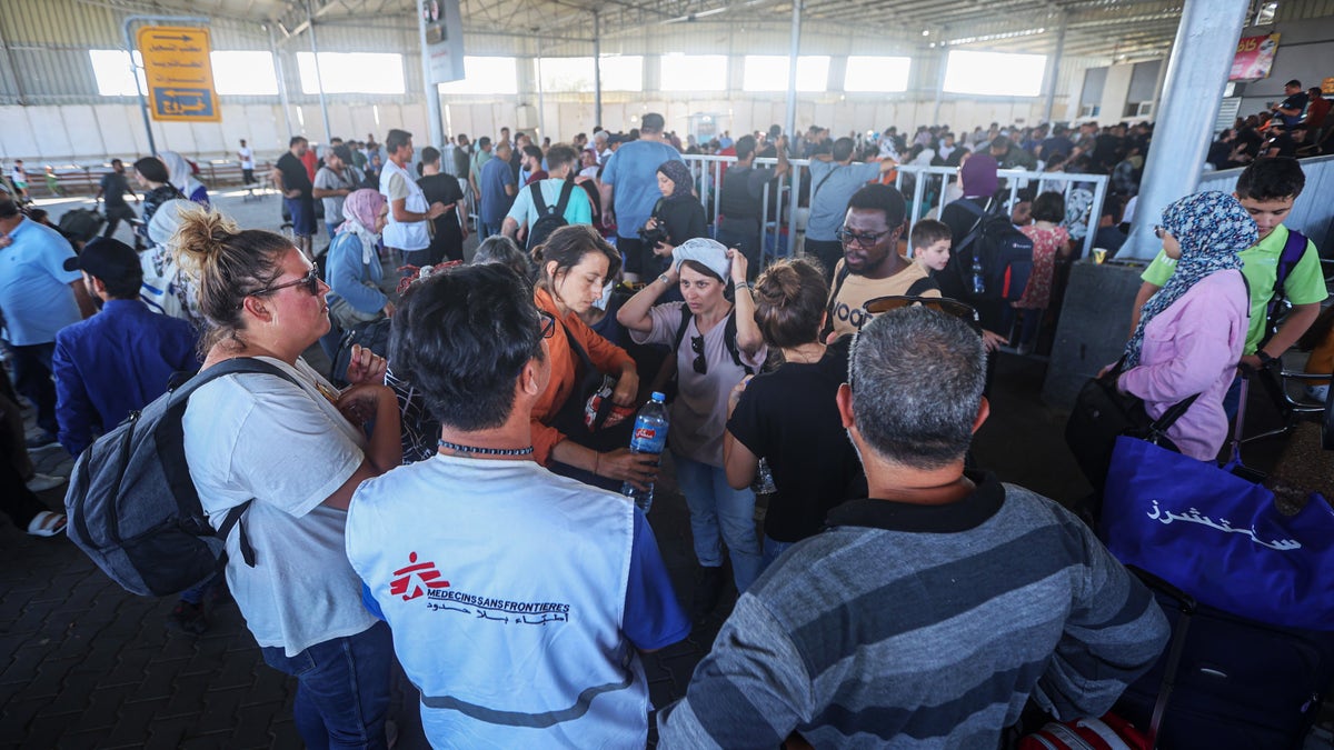 Foreign nationals stuck in palestine waiting at rafah crossing into egypt