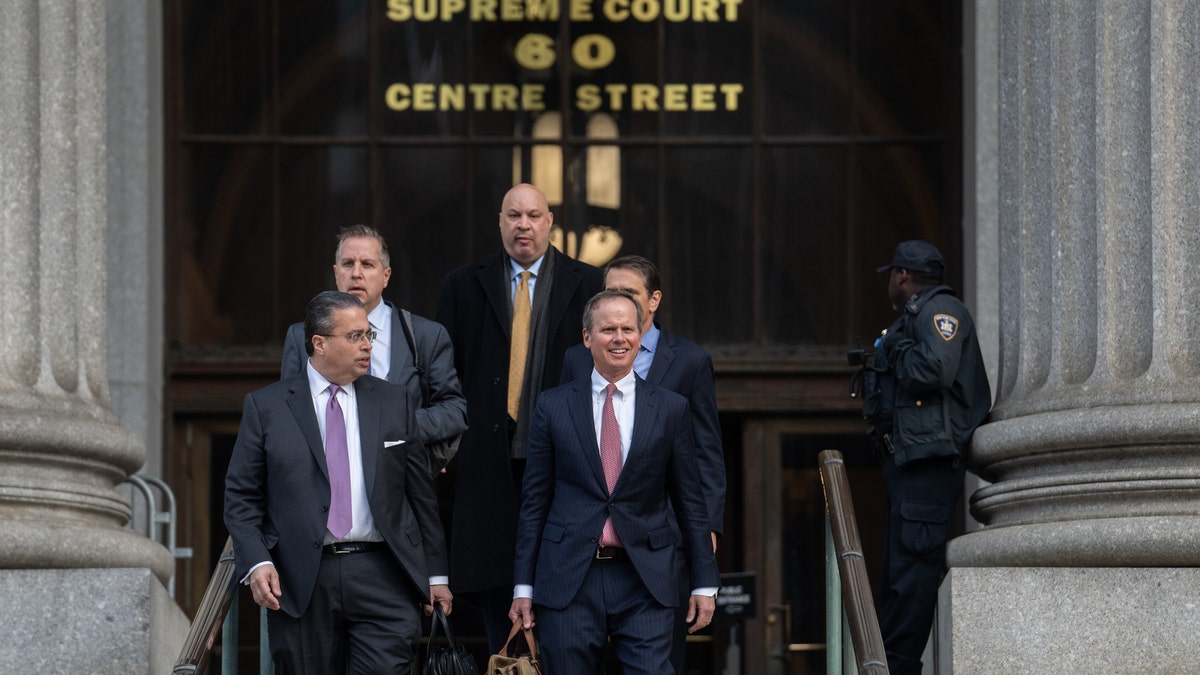 Chris Kise, attorney for former President Donald Trump, right, exits New York State Supreme Court in New York