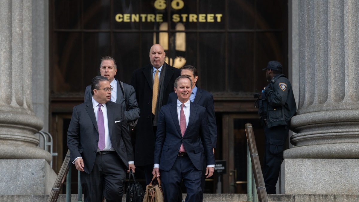 Chris Kise, attorney for former President Donald Trump, right, exits New York State Supreme Court in New York