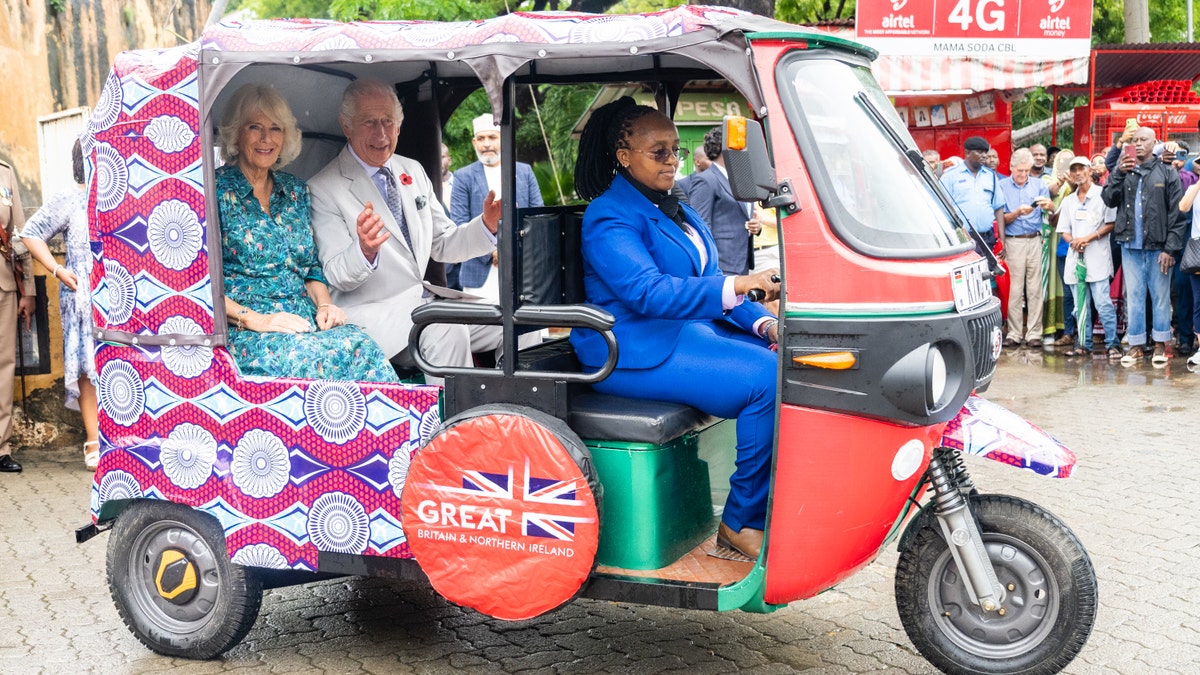 charles and camilla ride a tuk tuk in kenya