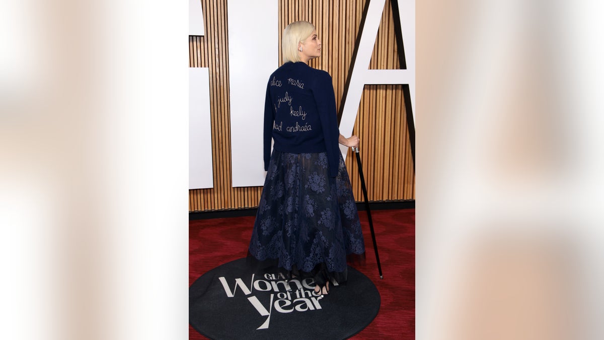 selma blair showing off sweater embroidered with name of disabilities advocates on the red carpet