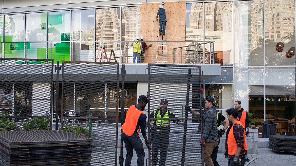 Workers build barricades outside APEC