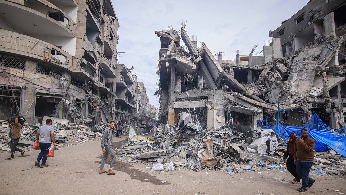 Palestinians gathered near a destroyed home