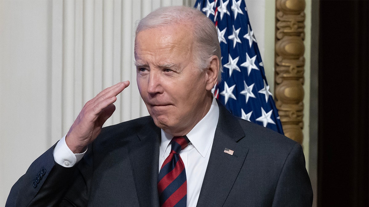 President Joe Biden saluting