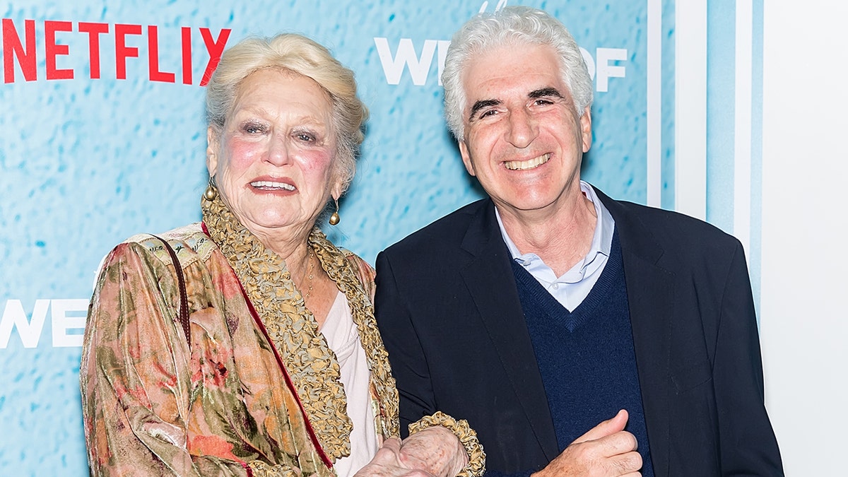 Suzanne Shepherd with a male on the carpet