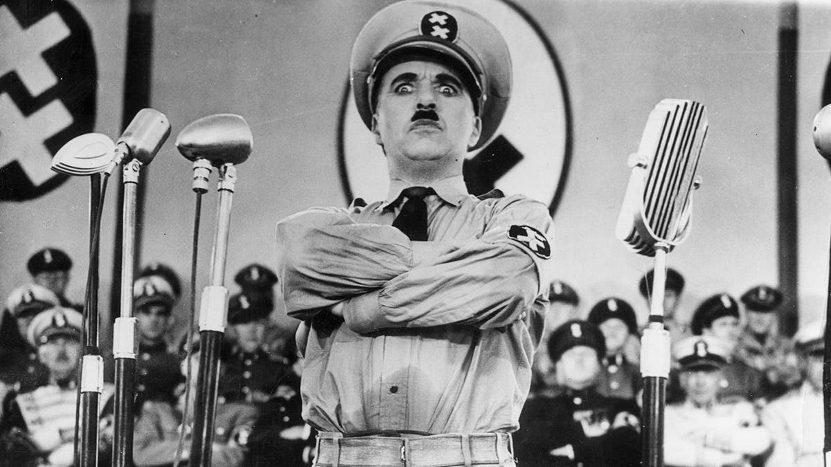 Charlie Chaplin dressed as Hitler in the great dictator