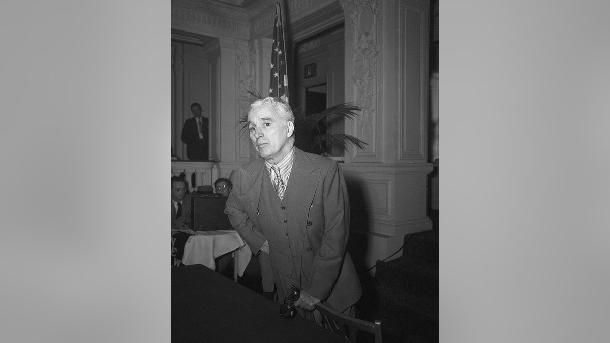 Charlie Chaplin looking worried in a suit