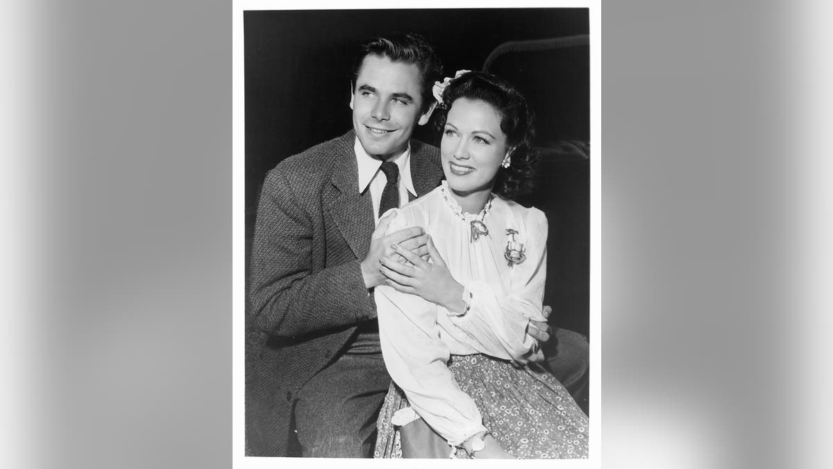 Glenn Ford leaning onto his wife Eleanor Powell