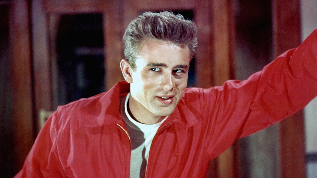 A close-up of James Dean wearing a red jacket