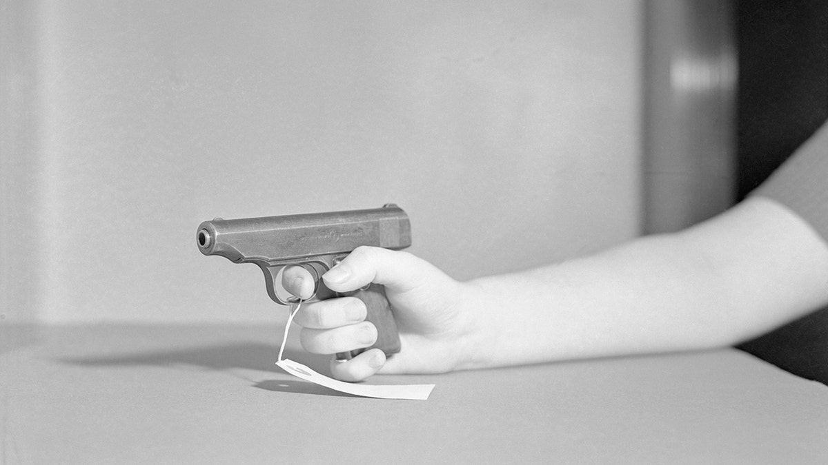 Joan Barrys gun being held by someone in court