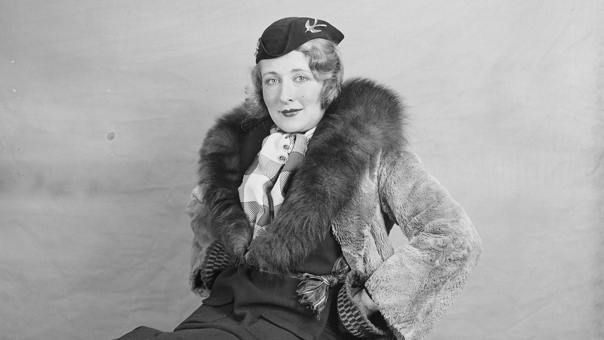 Mildred Harris posing in formal wear with a fur shawl