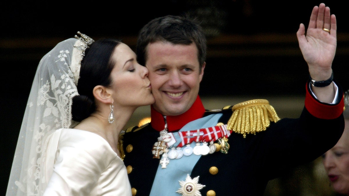 Princess Mary kissing Prince Frederik on their wedding day