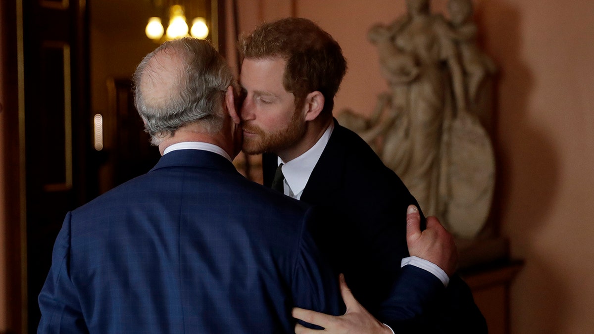 Prince Harry kissing his father on the cheek