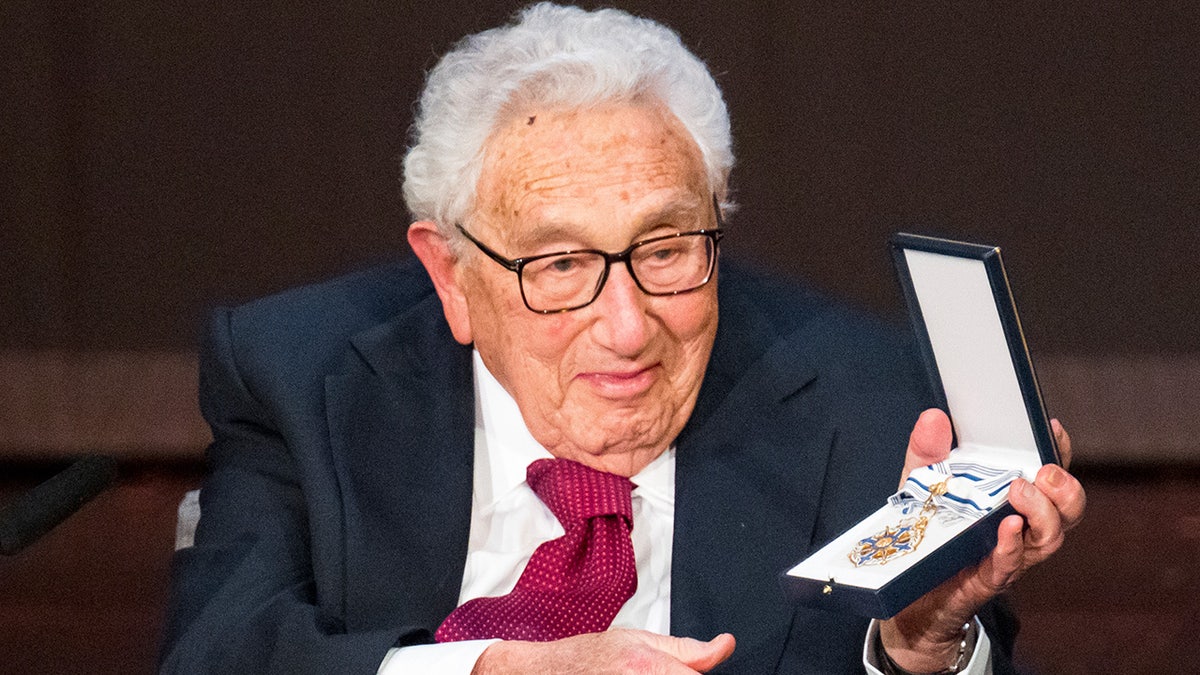 Henry Kissinger holds the Bavarian Order of Maximilian
