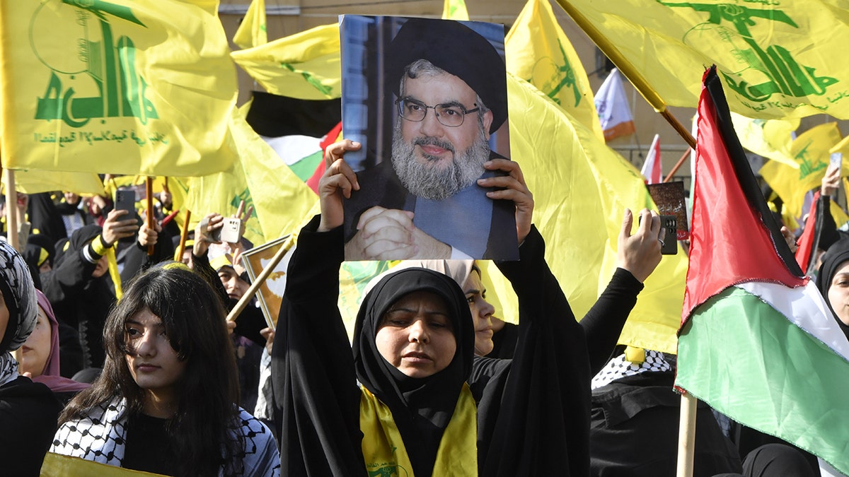 People watch video speech by Hezbollah leader Hassan Nasrallah