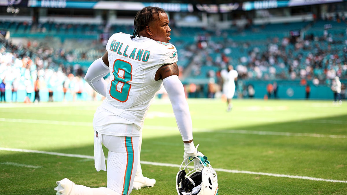 Jevon Holland stretches before a game