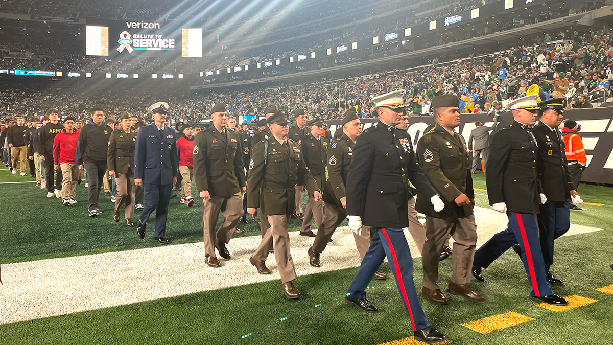 military members march off field
