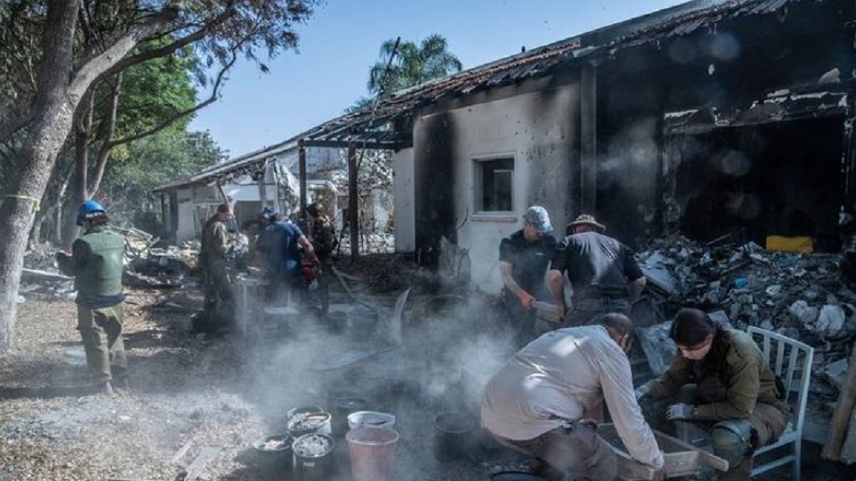 Archaeologists assist the IDF at a burnt home that was nearly destroyed during the Oct. 7 attack by Hamas