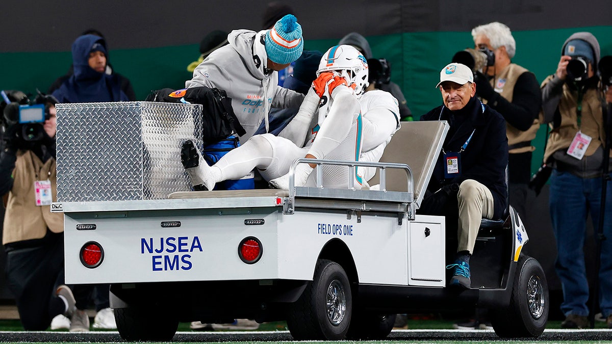 Jaelan Phillips is carted off the field