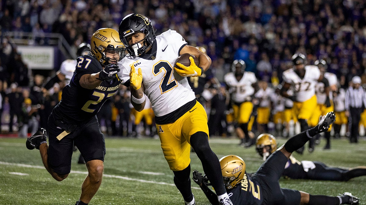 An Appalachian State player tries to outrun a James Madison player
