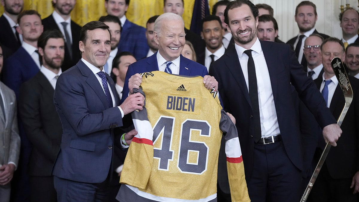 Joe Biden holds a jersey
