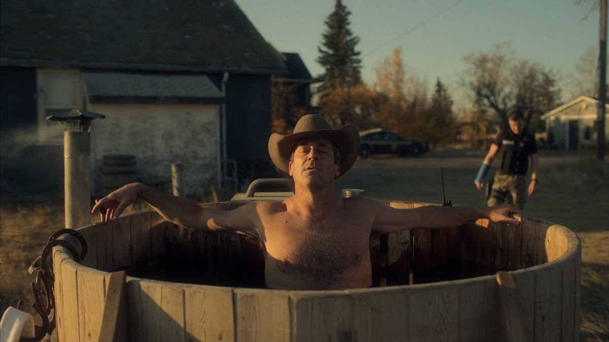 John Hamm in an outdoor wood paneled hot tub wearing a cowboy hat in a scene from "Fargo"