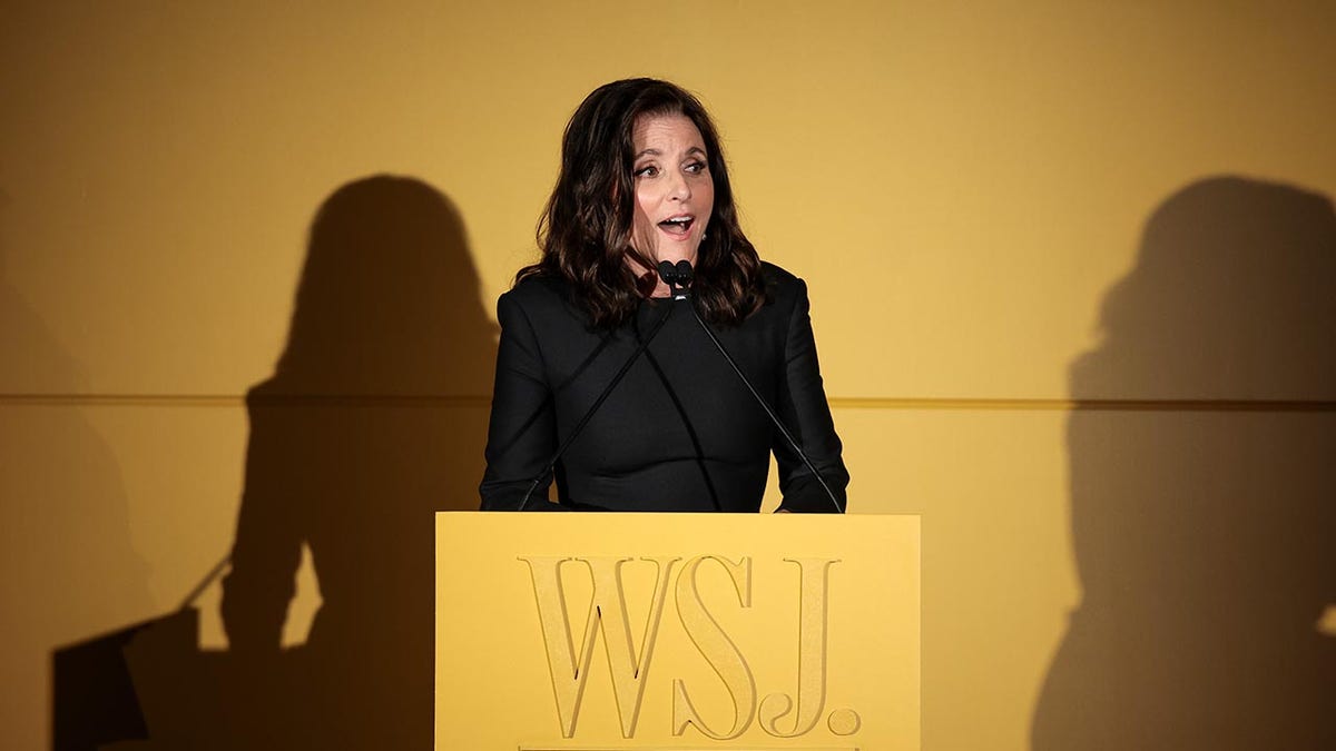 Julia Louis-Dreyfus standing at podium delivering speech