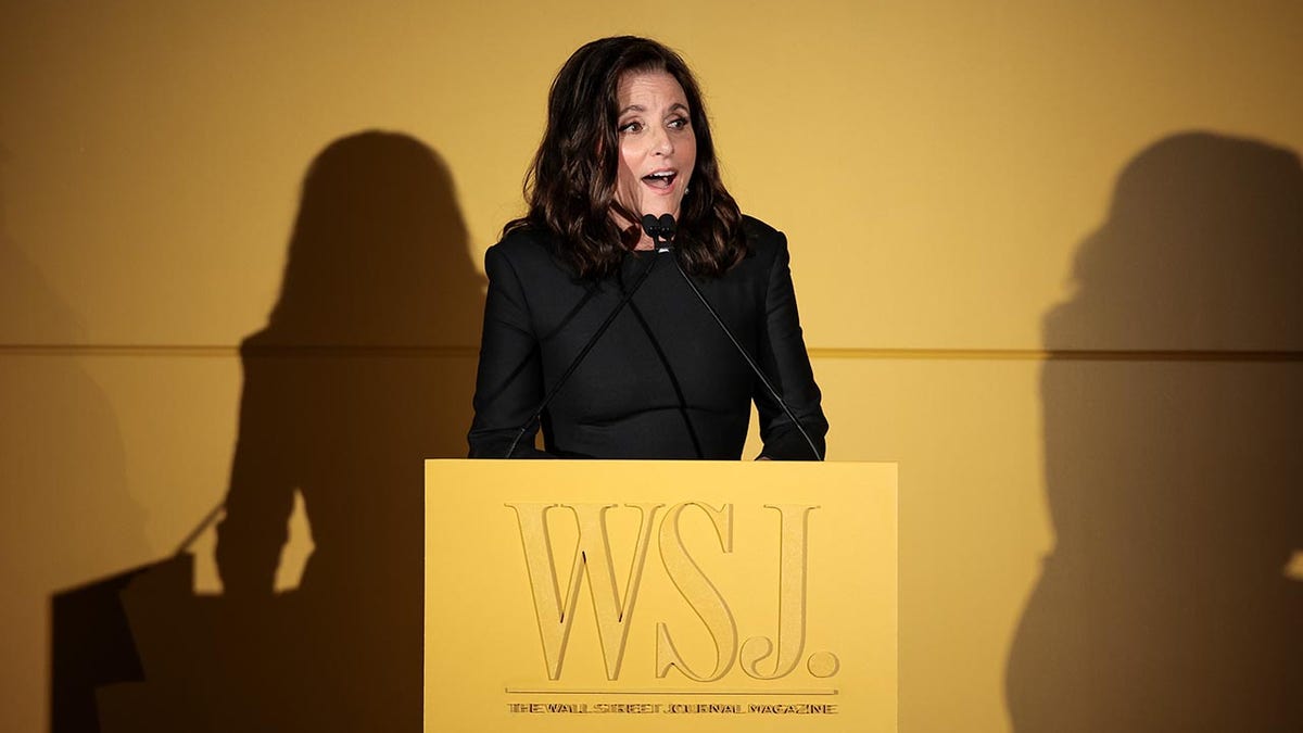 Julia Louis-Dreyfus standing at podium delivering speech