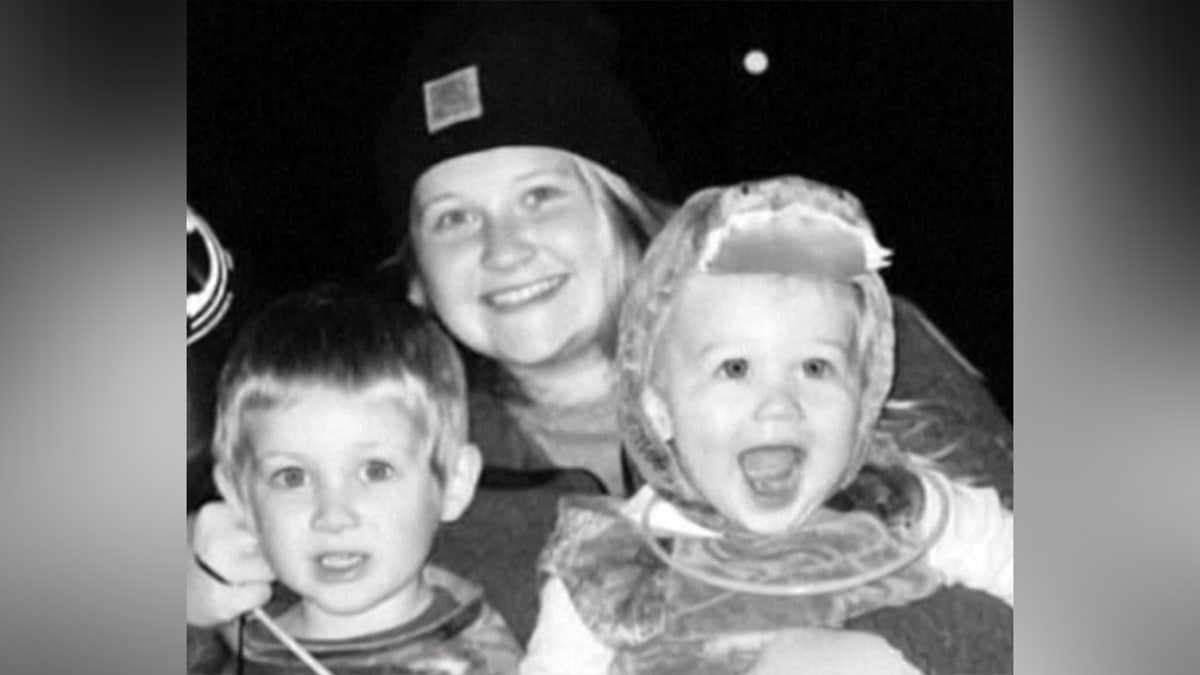 Black-and-white photo of mom with two boys.