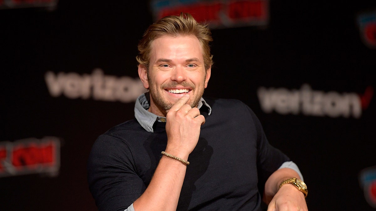 Kellan Lutz smiling on stage