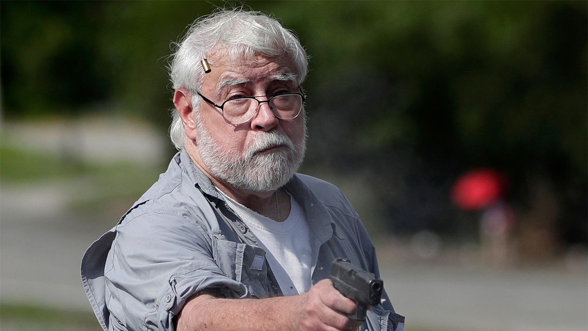 Kenneth Darlington holding a gun