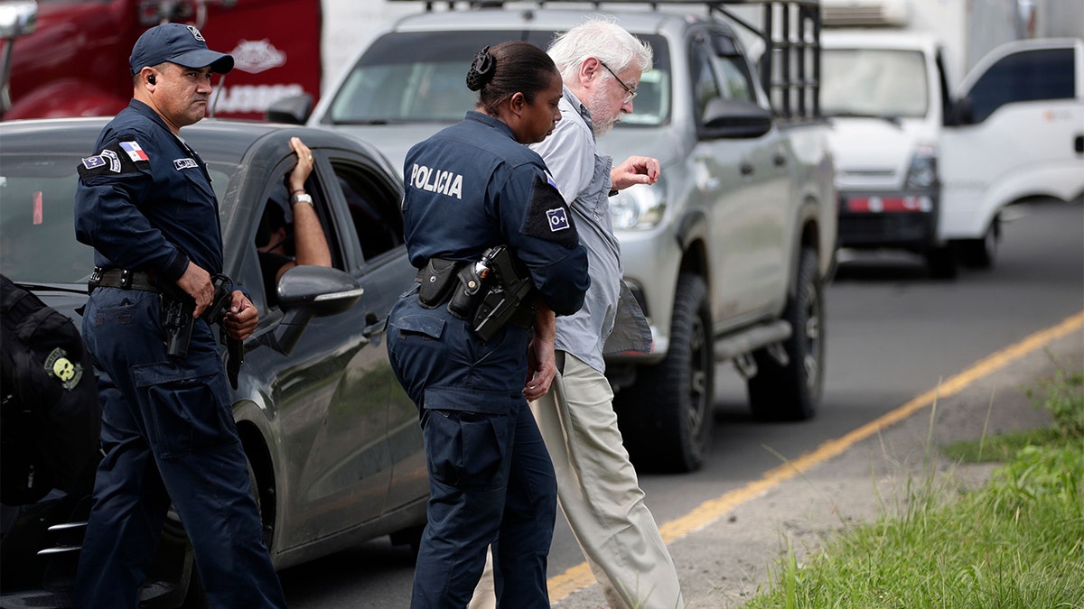 Kenneth Darlington is arrested and walked to a police squad car