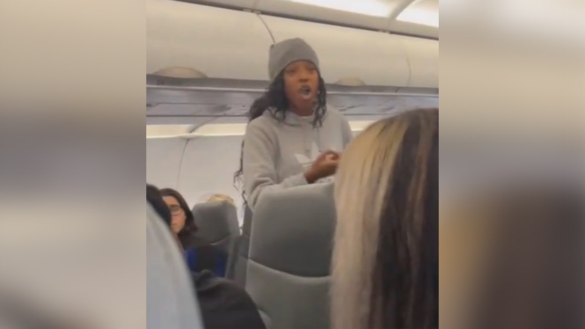 Woman preaching on Frontier Airlines flight