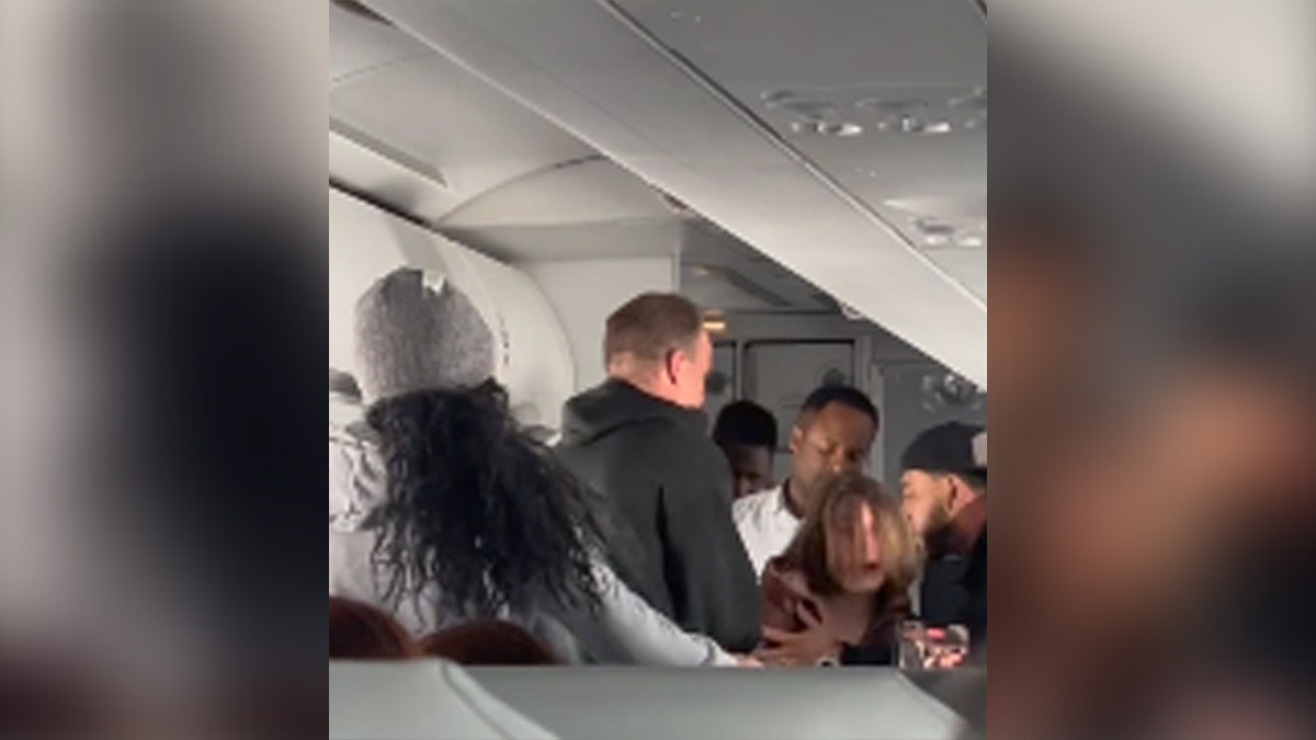 A woman is seen screaming on a Frontier Airlines flight