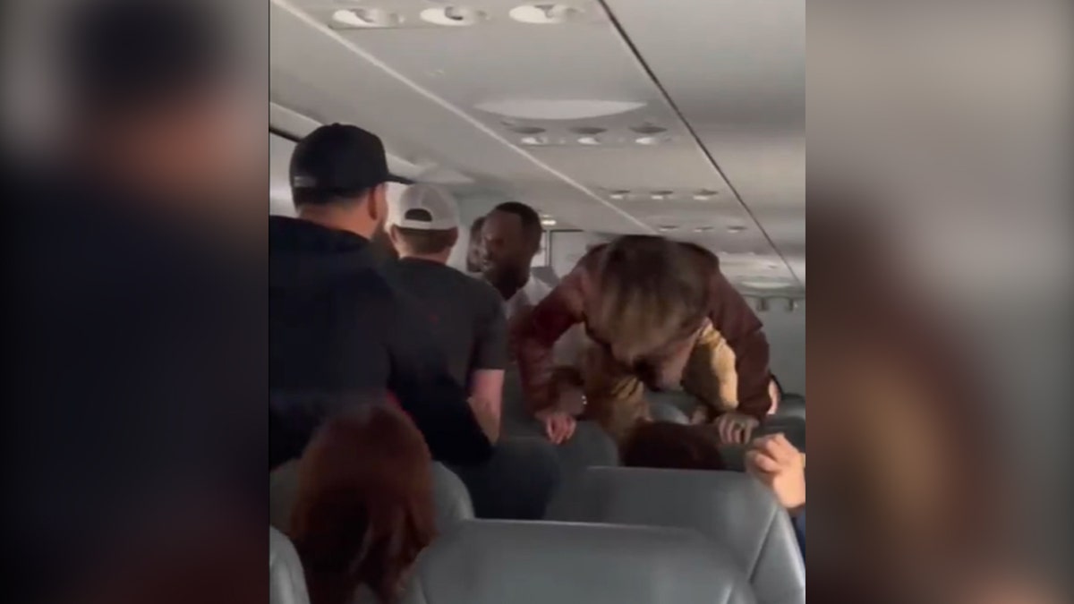 Woman jumping over seats on a plane