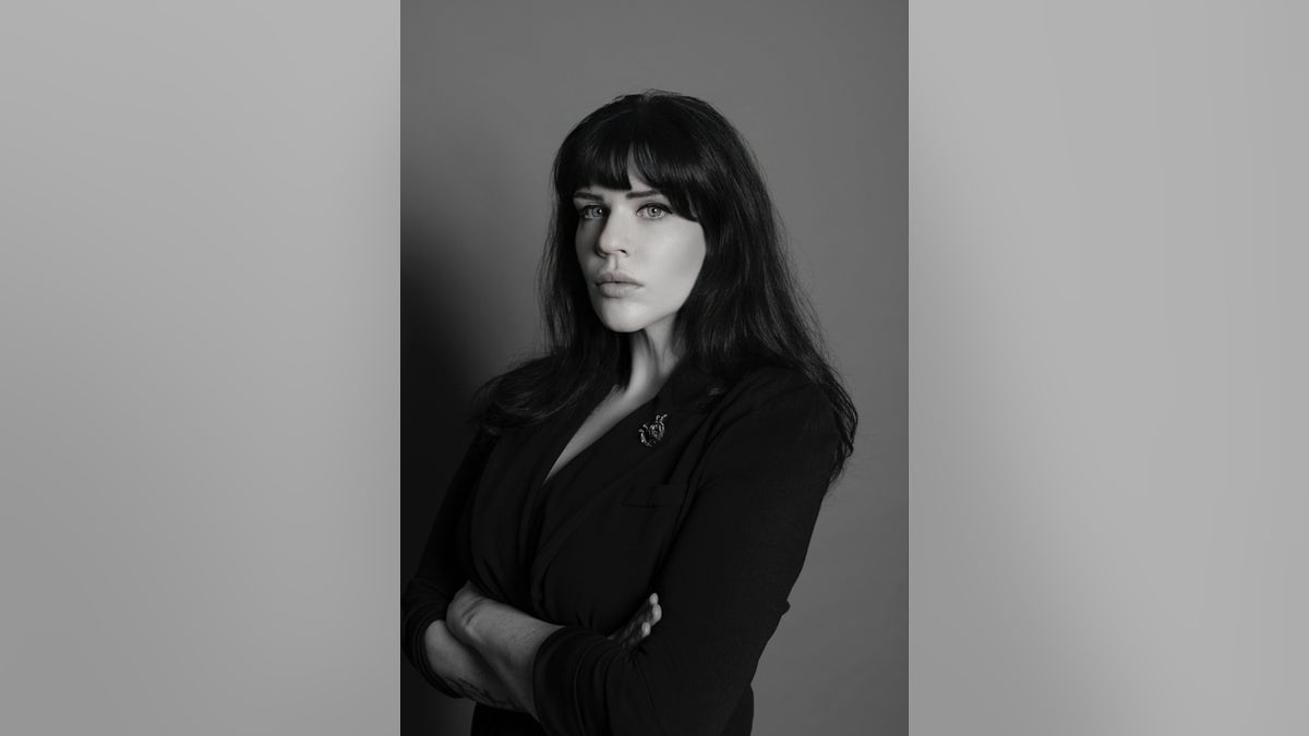 A black and white photo of Laurah Norton looking serious