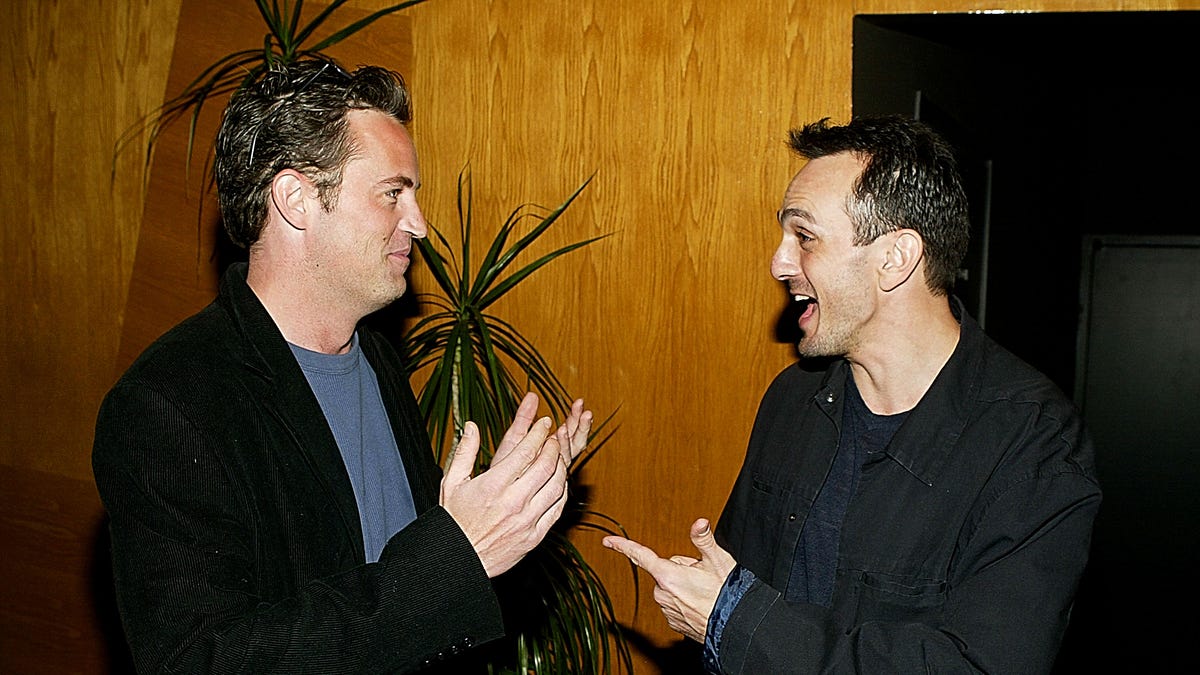 Matthew Perry and Hank Azaria in conversation with each other.
