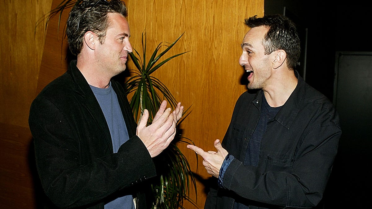 Matthew Perry and Hank Azaria in conversation with each other.