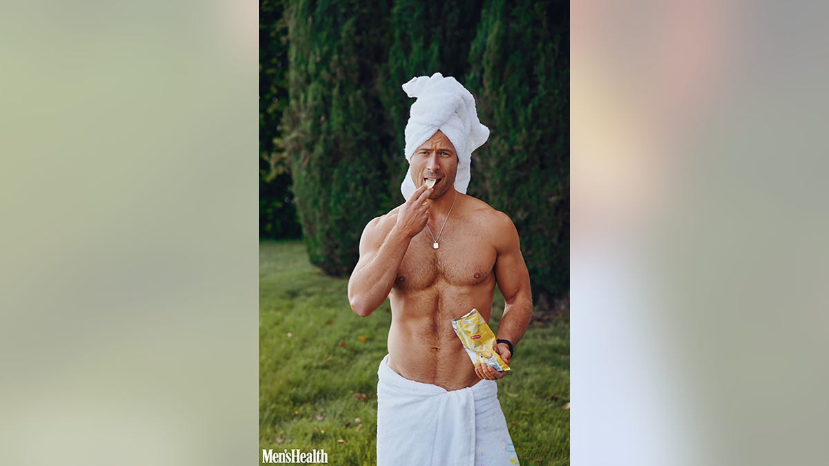 Glen Powell shirtless with a towel on