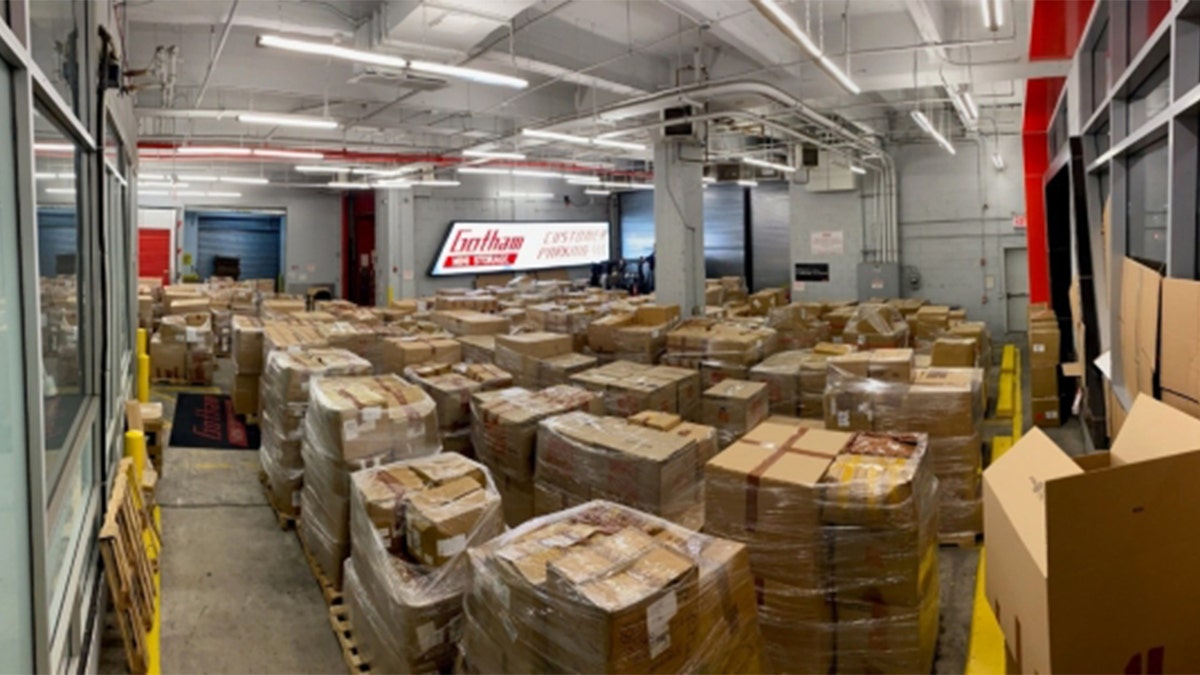 a room full of pallets of boxes that contain counterfeit goods