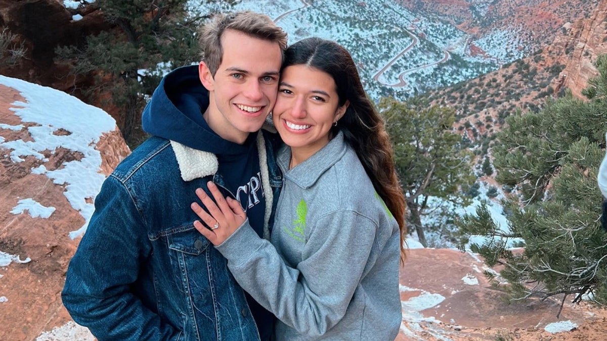 Nate and Mariana Kuhlman pose after his proposal in the snow-capped mountains.