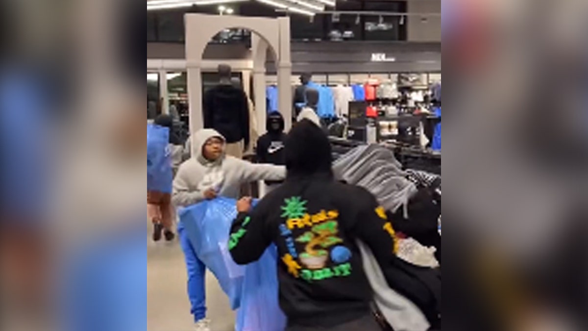 Robbers stealing clothes in a Nike store