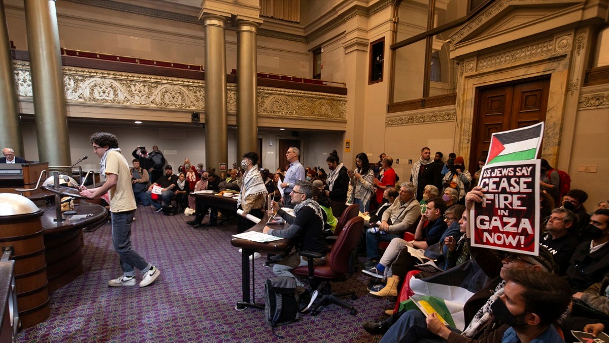 Protesters in an Oakland City Council chambers