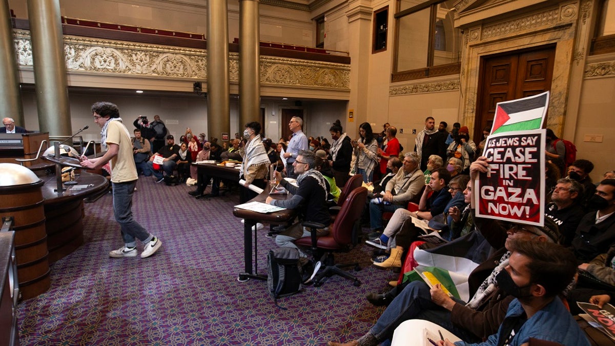 Protesters in an Oakland City Council chambers