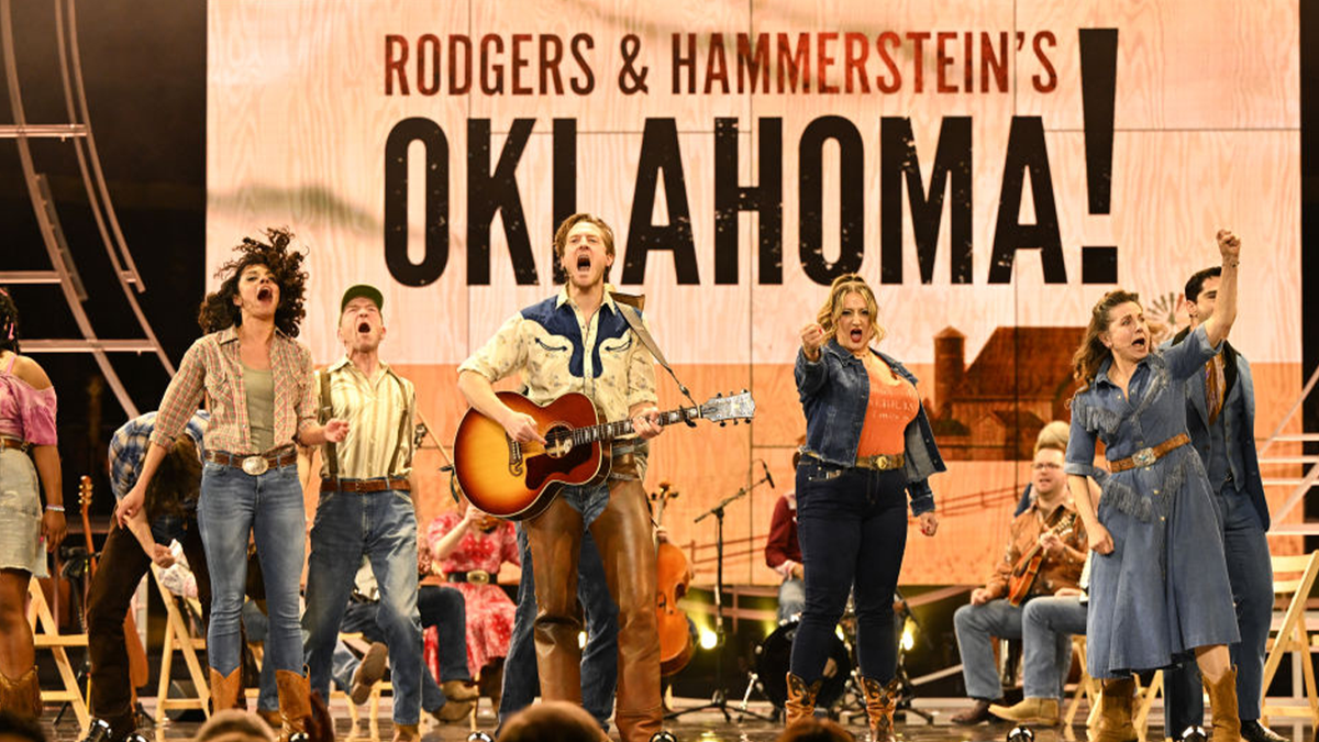 Cast of "Oklahoma!" singing