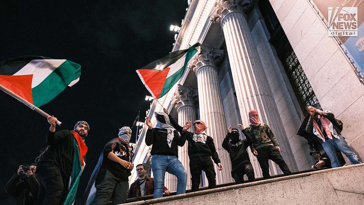 Pro-Palestine protestors gather outside of the Moynihan Train Hall in midtown Manhattan